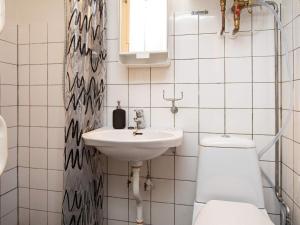 a bathroom with a sink and a toilet at 5 person holiday home in V ggerl se in Marielyst