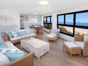 a living room with couches and chairs and a table at Parkyn Place 6 in Mooloolaba