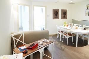 a living room with a dining room table and a couch at Porta Nuova Bergamo Apartments in Bergamo