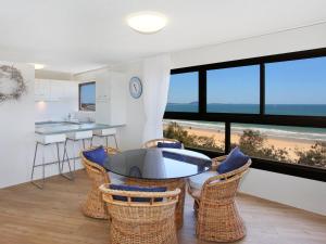 a kitchen and dining room with a view of the beach at Parkyn Place 6 in Mooloolaba