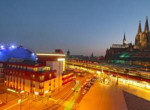 a view of a city at night with traffic at Kommerzhotel Köln in Cologne