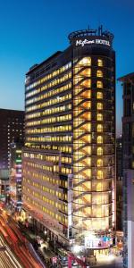 a tall building with a hotel sign on top of it at Migliore Hotel Seoul Myeongdong in Seoul