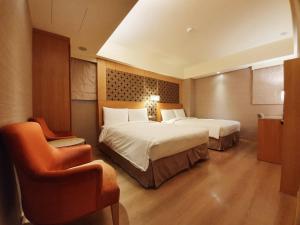 A bed or beds in a room at Guide Hotel Taipei NTU