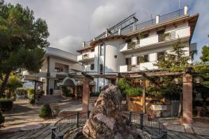 a building with a statue in front of it at Hotel Ristorante La Bilancia in Loreto Aprutino +17 photos