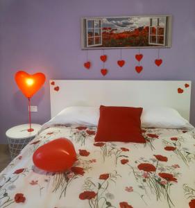 sypialnia z łóżkiem z czerwonym sercem na ścianie w obiekcie b&b Appiddaveru w Katanii