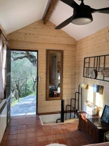 a room with a large window and a ceiling fan at Cabane de L Esteron in Gilette +25 photos