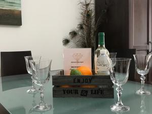 a table with four wine glasses and a bottle of wine at MALDONADO LUJO SUPERIOr CENTRO MALAGA in Málaga