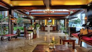 a lobby with couches and tables in a building at Best Western Resort Kuta in Kuta