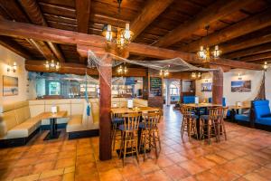 a restaurant with wooden ceilings and tables and chairs at La Port in Znojmo