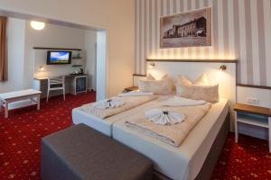 En eller flere senge i et værelse på Hotel Weisse Düne