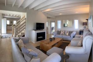 a large living room with couches and a fireplace at Summit Song - Thesen Island in Knysna