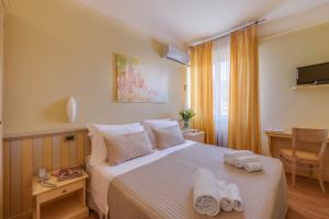 a hotel room with a bed with towels on it at Hotel Massimo in Marina di Cecina