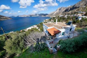 an aerial view of a house on a hill next to the water at Giameiko Traditional House Kalymnos in Kalymnos