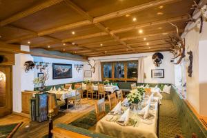 a restaurant with tables and chairs in a room at Haus Oberdorf in Zams