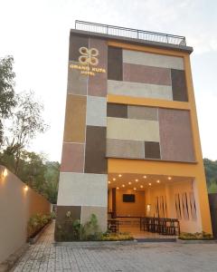 a building with a sign on the side of it at Grand Kuta Hotel in Kuta Lombok