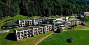 an aerial view of a building on a green field at Dom Wczasowy Jawor in Ustroń