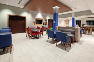 a waiting room with tables and chairs in a hospital at Holiday Inn Express Hotel & Suites Ventura Harbor, an IHG Hotel in Ventura