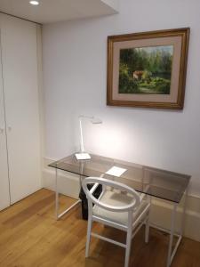 a wooden table in a room with a painting on the wall at EMAJ Boutique Hotel in Guimarães