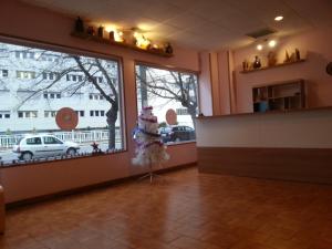 a room with a large window and a christmas tree at Pensión Pamplonabeds in Pamplona