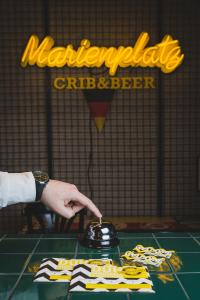 a person is reaching for a pot on a table at Hotel Marienplatz Podgorica in Podgorica