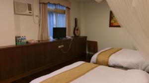 Rúm í herbergi á Emoonten Homestay