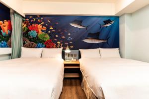 Kama o mga kama sa kuwarto sa Fish Hotel Kaohsiung