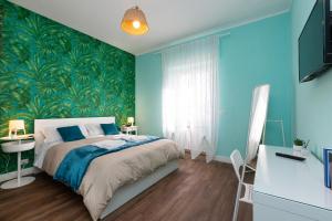 a bedroom with a bed and a green wall at CIACCIO HOUSE near airport in Fiumicino