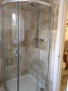 a shower stall with a glass shower door at BELESME, PRIVATE ANNEX in Bridgnorth