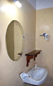 a bathroom with a sink and a mirror on the wall at JamboHouse Lamu in Lamu