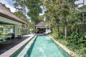a swimming pool in the backyard of a house at Kayumanis Nusa Dua Private Villa & Spa in Nusa Dua