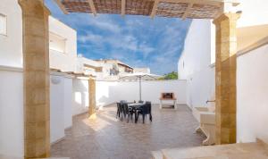 a dining room with white walls and a table and chairs at Villetta Maredoro - Fronte Spiaggia Pescoluse in Marina di Pescoluse