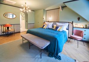 a bedroom with a bed and a pink chair at Cora Apartments in Leipzig