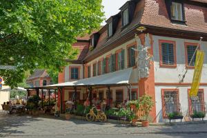 a building with a market in front of it at Hotel Brudermühle in Bamberg