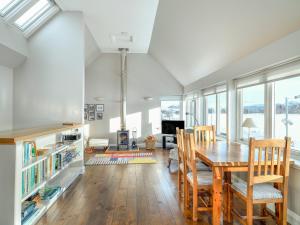 a dining room with a table and chairs and windows at Signal Box in Newtonmore