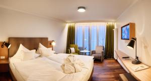 Postel nebo postele na pokoji v ubytování Hotel Villa Hügel