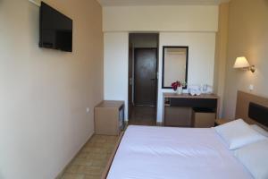 A bed or beds in a room at Rhodian Sun Hotel