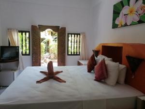 una camera da letto con un letto con una stella marina di Puri Oka Beach Bungalows a Candidasa