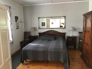 a bedroom with a bed and a mirror on the wall at HimosKukkula in Jämsä