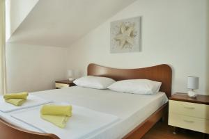 Posteľ alebo postele v izbe v ubytovaní Apartments Sandy Beach
