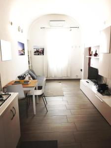 a kitchen and living room with a table and a kitchen and a dining room at white house in Bari