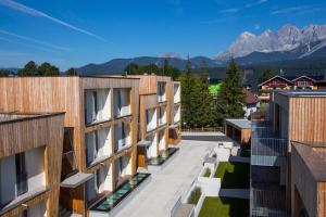 an aerial view of buildings with mountains in the background at Alpenrock Schladming by ALPS RESORTS in Schladming