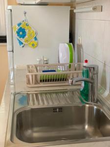 a kitchen sink with a dish drying rack next to it at Apartments Kristina in Klenovica