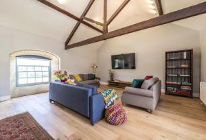 a living room with two couches and a tv at Drackenorth Lodge in Beaminster