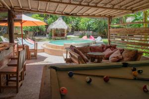 a pool room with a pool table and a pool table at Jati Village, Party Hostel and Bungalows in Gili Trawangan