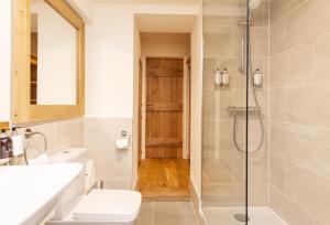 a bathroom with a shower and a toilet and a sink at Evergreen in Bransgore