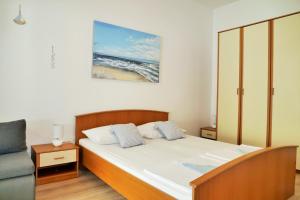 Posteľ alebo postele v izbe v ubytovaní Apartments Sandy Beach