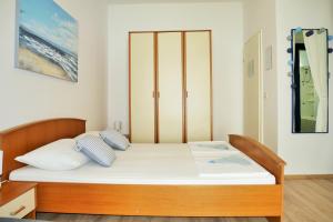 Posteľ alebo postele v izbe v ubytovaní Apartments Sandy Beach