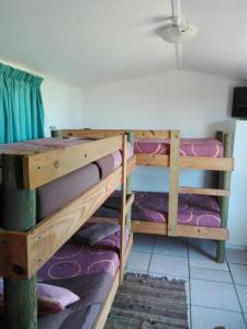 a room with two bunk beds in a room at The Hexagon Wildlife Conservation in Uitenhage