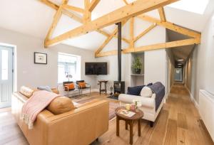 a living room with a couch and a table at Stapleford Farm Cottages in Beaminster
