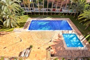 an overhead view of two swimming pools in a yard at Apartamentos Paraíso Centro - BenidormParaíso in Benidorm